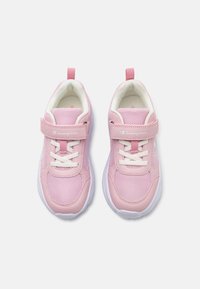 Pink athletic shoes with mesh upper, white accents, lace-up closure, Velcro strap, and rubber outsole. Features logo on side and heel tab.