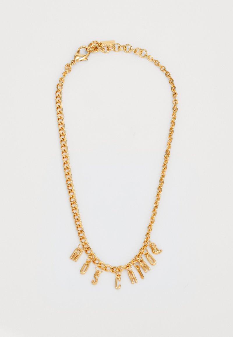 Kuldne kettkaelus, millel on ripatsitähed, mis koosnevad sõnast "MOSCATO". Ühtlane pind, millel on konksuga sulgur ja erineva suurusega lingid.