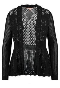 Svart stickad cardigan med öppen design, som har varierande texturer och mönster. Långa ärmar och utsvängd nederkant med en loose fit.