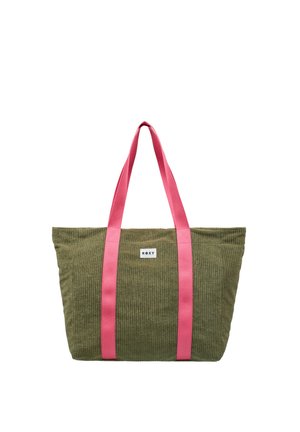 Olijfgroene corduroy draagtas met felroze hengsels en een klein wit "ROXY" logo patch aan de voorkant.