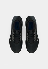 Black athletic shoes with a textured upper, featuring gray accents, perforations, and a blue insole. Laces are integrated into the design.