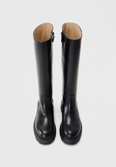 Black leather knee-high boots with a smooth finish, rounded toe, and a chunky sole. Features a zipper closure at the back.