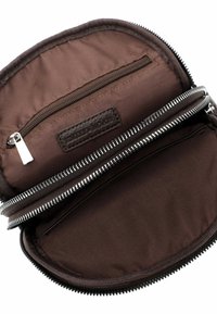 Avatud tumepruun kott hõbedase tõmblukuga, mis paljastab väikese tõmblukuga tasku ja sisemise pesatasku.