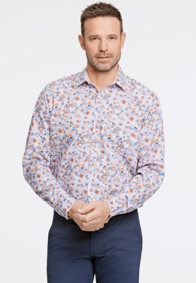 Chemise à manches longues dans des couleurs pastel claires, avec un motif floral agrémenté de détails oranges et bleus. Design à boutons, tissu doux, col classique.