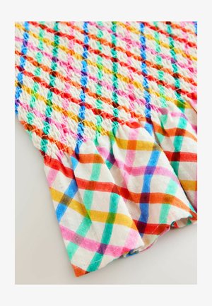 Värikäs smokkikangas timantinmuotoisella kuviolla vaaleanpunaisissa, oransseissa, vihreissä, sinisissä ja keltaisissa sävyissä; reunassa rypytys.