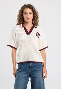 Knit polo-style top in cream with burgundy accents, featuring a v-neck, short sleeves, and a sporty embroidered '01' detail.