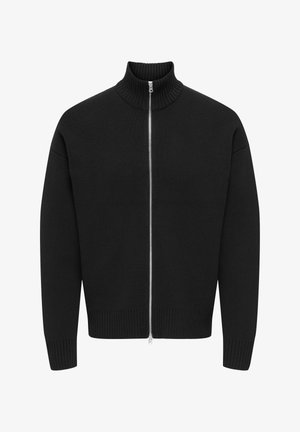 Pull en maille noire avec un col montant côtelé, une fermeture éclair intégrale à l'avant et des poignets et ourlet côtelés. Le matériau texturé offre un aspect chaleureux.