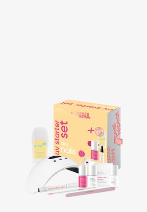 Kit de départ UV pour ongles secs avec lampe, vernis à ongles, dissolvant, stylo de soin, lime à ongles et lotion hydratante dans un emballage jaune et rose.