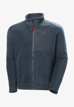 Fleece jacket in dark blue with a high collar, full front zipper, two zippered side pockets, and a chest pocket. Features red zipper pulls.