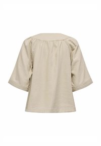 Beige Kurzarmtop aus weichem Stoff mit lockerer Passform, mit rundem Kragen und gerafftem Detail entlang des Rückens.