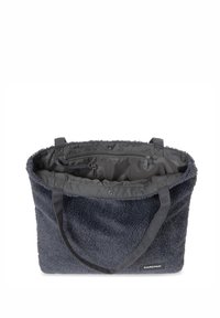 Borsa tote grigia scura con un'esterno peloso, due manici robusti e un interno foderato liscio che presenta una tasca con zip e una chiusura sicura.