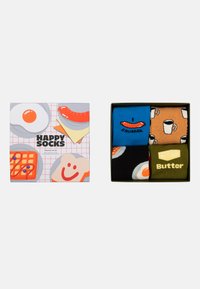 Vier paar sokken in een geschenkdoos met voedselontwerpen: worst, boter, koffie en gebakken ei. Kleurrijk, katoenmix materiaal. Verpakt ontwerp.