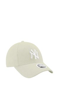 Light green corduroy baseball cap with white embroidered logo, curved brim, and sticker label on the visor. Textured fabric and stitching details.