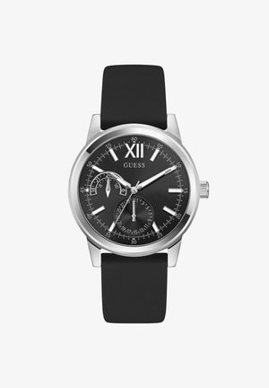 Kerek fekete Guess karóra ezüst tokkal, fekete szíjjal, római XII számmal és két kisebb számlappal, amelyek az időt és a dátumot mutatják 24 órás formátumban.