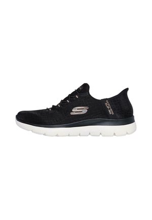 Black athletic sneaker with mesh upper, white sole, rounded toe, and decorative stitching. Features brand logo on the side and textured accents.