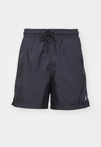Black athletic shorts made of lightweight fabric, featuring an elastic waistband, drawstring, and a small logo on the bottom right leg.