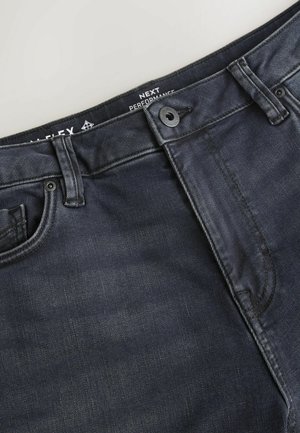 Dunkelblaue Jeans aus Denim mit einer glatten Textur, klassischem Fünf-Taschen-Design und einem vorderen Knopfverschluss mit kontrastierenden Nahtdetails.