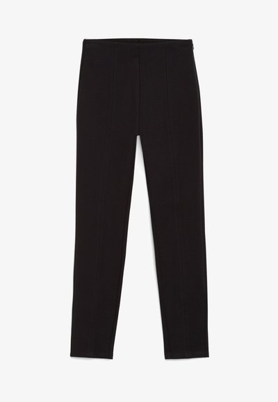 Black leggings made of stretch fabric, featuring a fitted design, seam detailing, and an elastic waistband. Smooth texture, full-length fit.