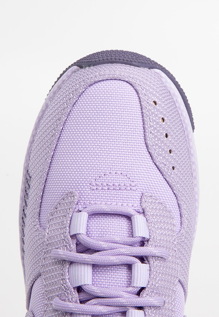 Zapatilla deportiva de color púrpura claro con textura de malla, collar acolchado y diseño con cordones. Presenta una suela de goma duradera y detalles de costura sutiles.