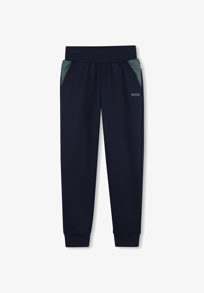 Pantalon de sport bleu marine avec une texture douce, des poignets ajustés et des poches latérales en mesh respirant. Présente un détail subtil du logo BOSS.