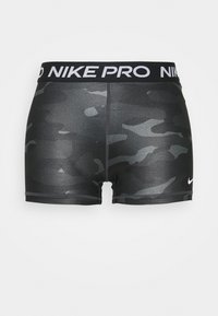 Szorty w czarny wzór kamuflażu z szerokim elastycznym paskiem w talii z napisem "NIKE PRO" w białym kolorze oraz krótkim, dopasowanym krojem. Gładka tekstura.