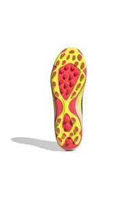 Kenki kengänpohja, jossa on kirkas keltainen pohja ja punaiset pitokärjet. Muotoilu on virtaviivainen, teksturoitu pinta ja kuvioitu pito.