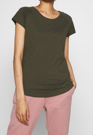 Olivgroen T-shirt met korte mouwen en een ronde hals, zachte katoenstructuur en een ontspannen pasvorm, gecombineerd met lichtroze broek.