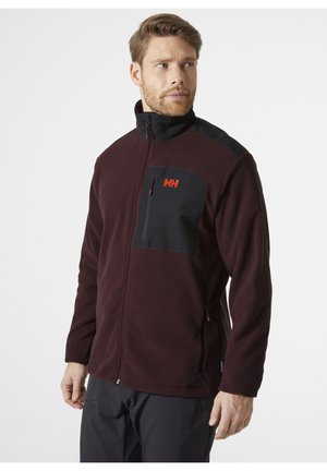 Burgundy fleece jacket with a black shoulder panel, zippered chest pocket, and logo. Features a stand-up collar and zippered front closure.