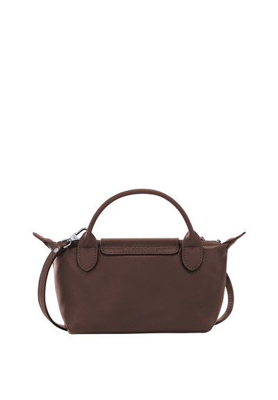 Small brown leather handbag with top handles and a detachable shoulder strap on a white background.