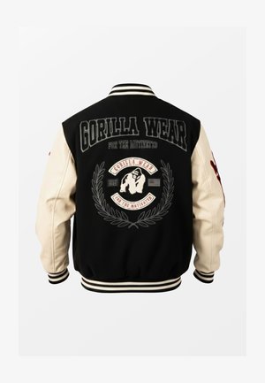 Black and white varsity jacket with "Gorilla Wear" text, a gorilla logo, laurel wreath, and striped cuffs and collar.