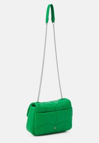 Green quilted handbag with a soft texture, featuring a silver chain strap and a padded design characterized by geometric patterns.