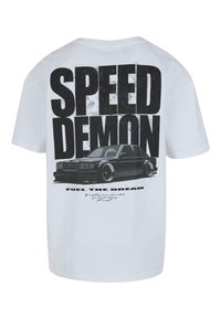 White cotton t-shirt featuring a black graphic print of a car and bold text "SPEED DEMON" and "FUEL THE DREAM." Standard crew neck design.