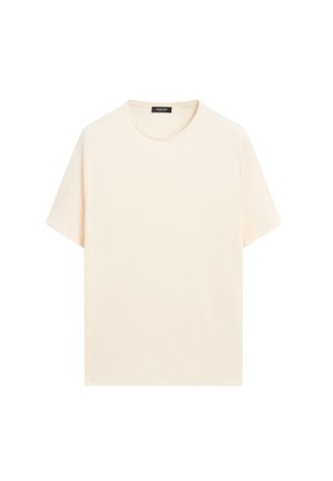 T-shirt à manches courtes, de couleur crème, en coton doux. Il présente un col rond et une coupe décontractée sans motifs ni dessins.
