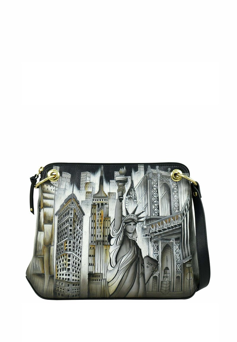 Schoudertas met een zilver- en zwart ontwerp, afgebeeld met het Vrijheidsbeeld en de stadsagenda, inclusief gouden accenten en ritsen.