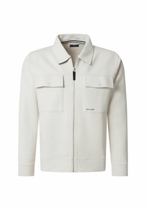 White zip-up jacket made from soft fabric, featuring a pointed collar, two front pockets, and subtle logo detailing on the chest.