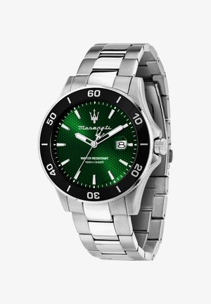 Silver stainless steel watch with a green patterned dial, black bezel, and date window. Features luminous hands and water resistance up to 100m.