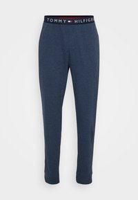 Marineblauwe Tommy Hilfiger loungebroek met elastische tailleband, voorzien van Tommy Hilfiger merknaam en logo in wit en rood.