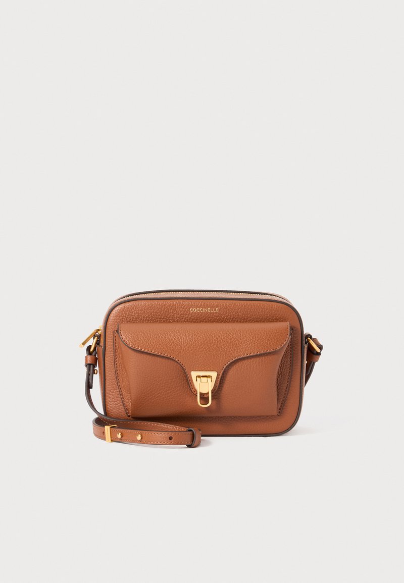 Tan leather crossbody bag with a textured finish, featuring a front flap pocket and gold-tone hardware. Adjustable strap included.