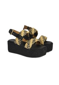 Woven black platform sandals with natural-colored braided straps and black leather accents. Features adjustable ankle strap and textured sole.