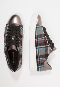 Zapatillas de cuadros de felpa con un patrón en gris, negro y verde azulado, acentos metálicos bronce, cordones negros y suelas de goma blanca.