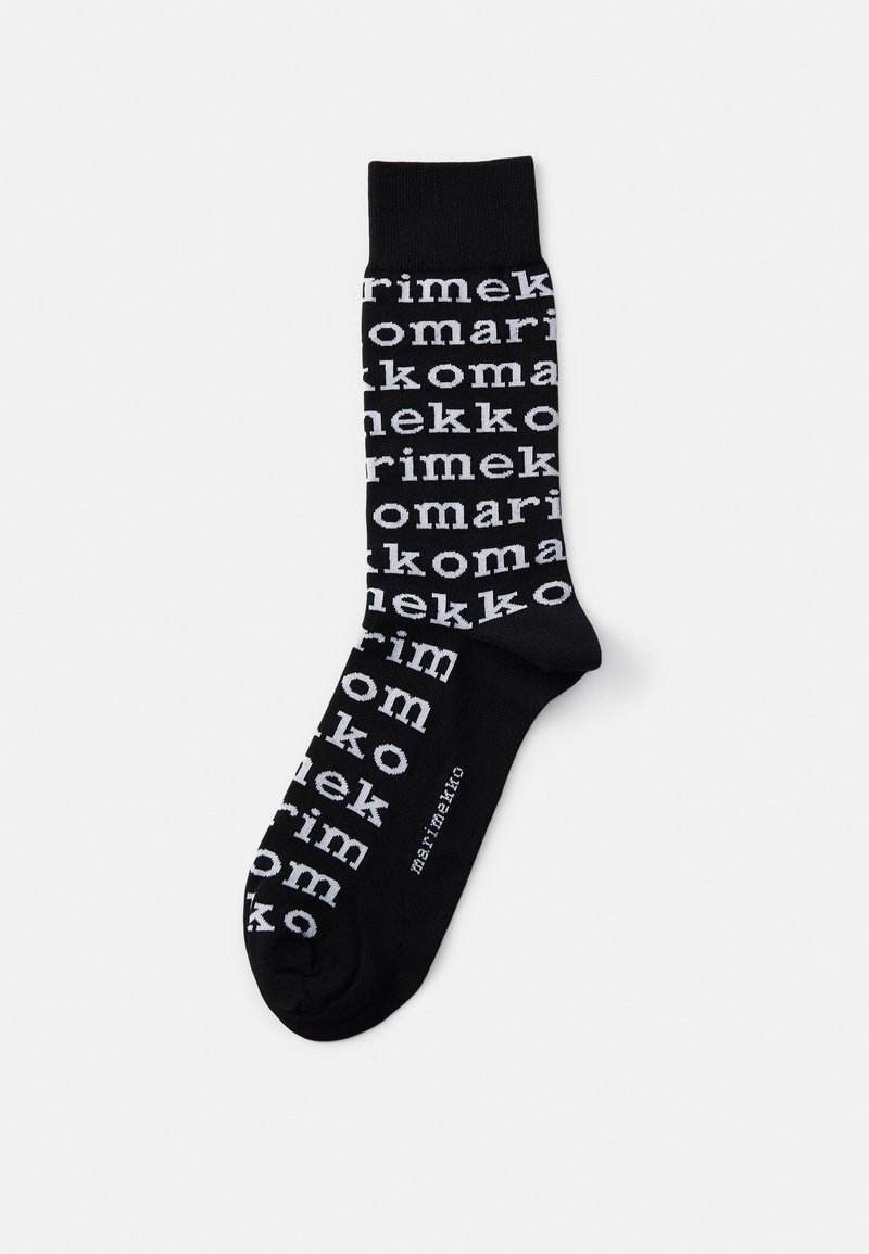 Black socks featuring a repeating pattern of the word "marimekko" in varying white font sizes, with a ribbed cuff. Smooth texture.