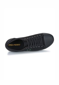 Zapatillas de lona negras con puntera redonda, ojales de metal, cordones negros, suela de goma texturizada y logo de laurel verde bordado. Texto dorado "FRED PERRY" en el interior.