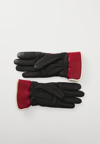 Gants en cuir noir avec des poignets en cuir rouge ; présentent une finition texturée, un élastique aux poignets et un design de doigts lisses.
