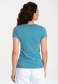 Light blue fitted T-shirt with short sleeves and a round neckline. Soft cotton material, smooth texture, and minimal stitching details.