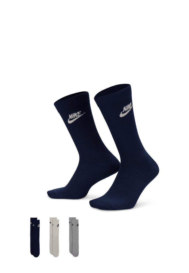 Marineblaue Nike-Socken mit geribbelter Textur und silbernem Logo. Enthält drei zusätzliche Paare in marineblau, hellgrau und dunkelgrau.