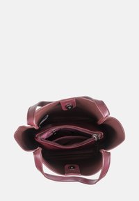Structured burgundy leather tote with double handles, open top, and interior pockets. Features a snap closure and zippered compartment.