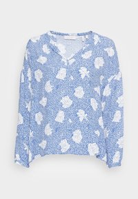 Blusa a maniche lunghe blu con un motivo floreale bianco. Presenta un collo a V, una vestibilità rilassata e un tessuto testurizzato con una leggera lucentezza.