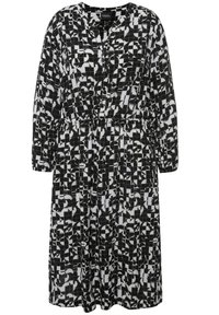 Schwarzes und weißes gemustertes Kleid aus Stoff, mit V-Ausschnitt, Knopfleiste, langen Ärmeln und einem elastischen Bund für eine lockere Passform.