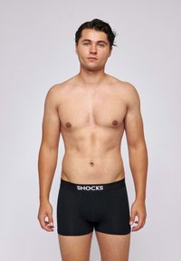 Black boxer briefs with a SNOCKS branded elastic waistband, featuring a fitted design and smooth fabric texture.