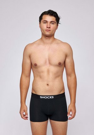 Black boxer briefs with a SNOCKS branded elastic waistband, featuring a fitted design and smooth fabric texture.